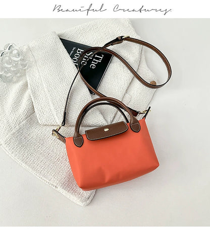 Nylon Crossbody Bag with Brown Leather Trim - Compact Foldable Handbag with Adjustable Strap